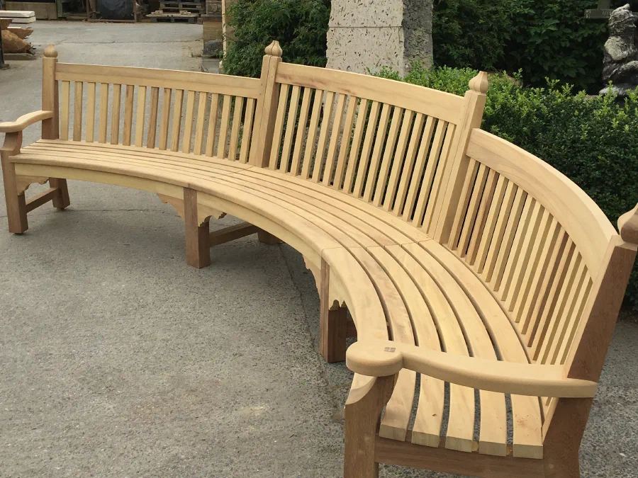Long curved garden bench assembled in the workshop yard