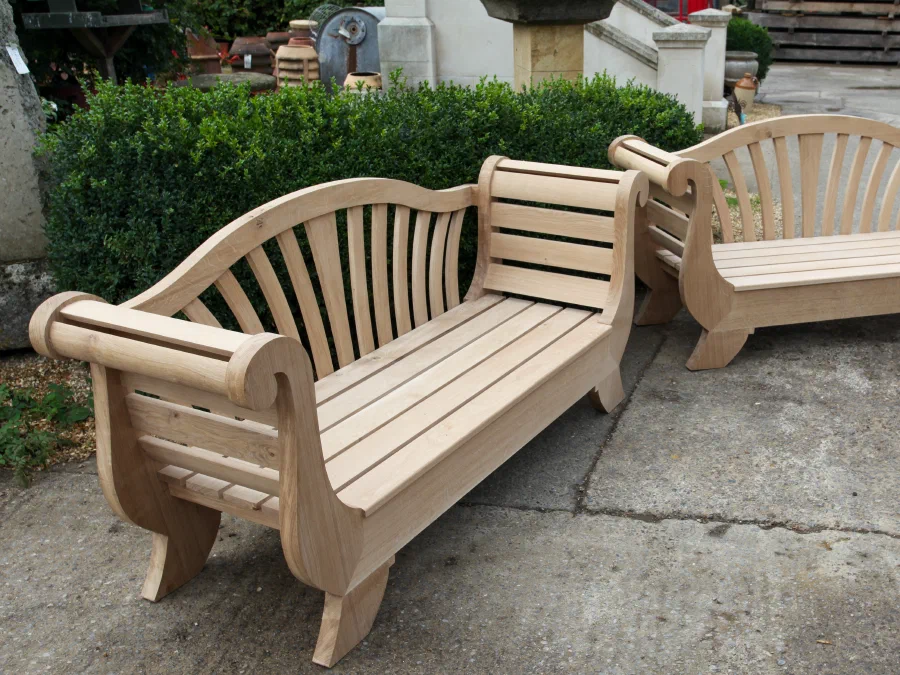 Pair of unfinished shaped garden benches outside the workshop