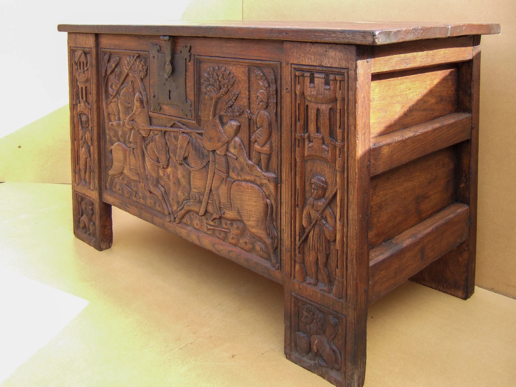 Carved oak chest with panelled front