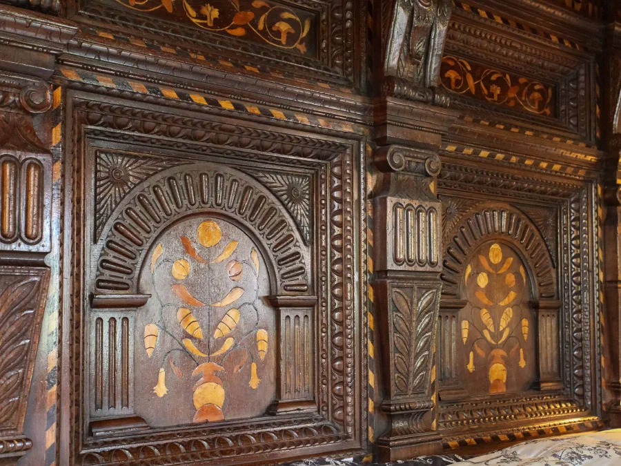 Carved and inlaid headboard panels on our oak replica of the Corbet bed