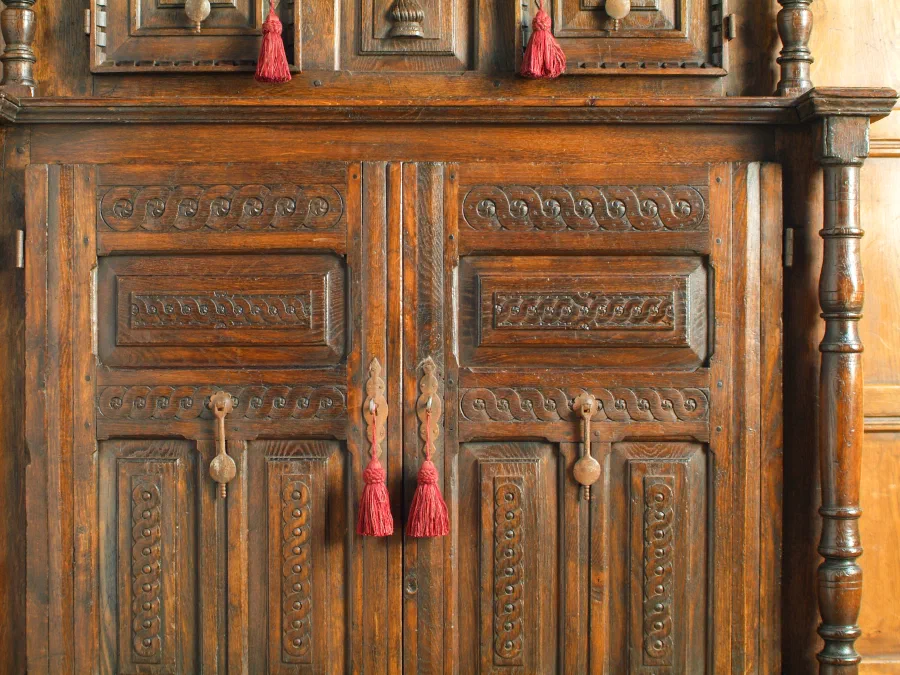 Carved doors and turned columns on an oak court cupboard