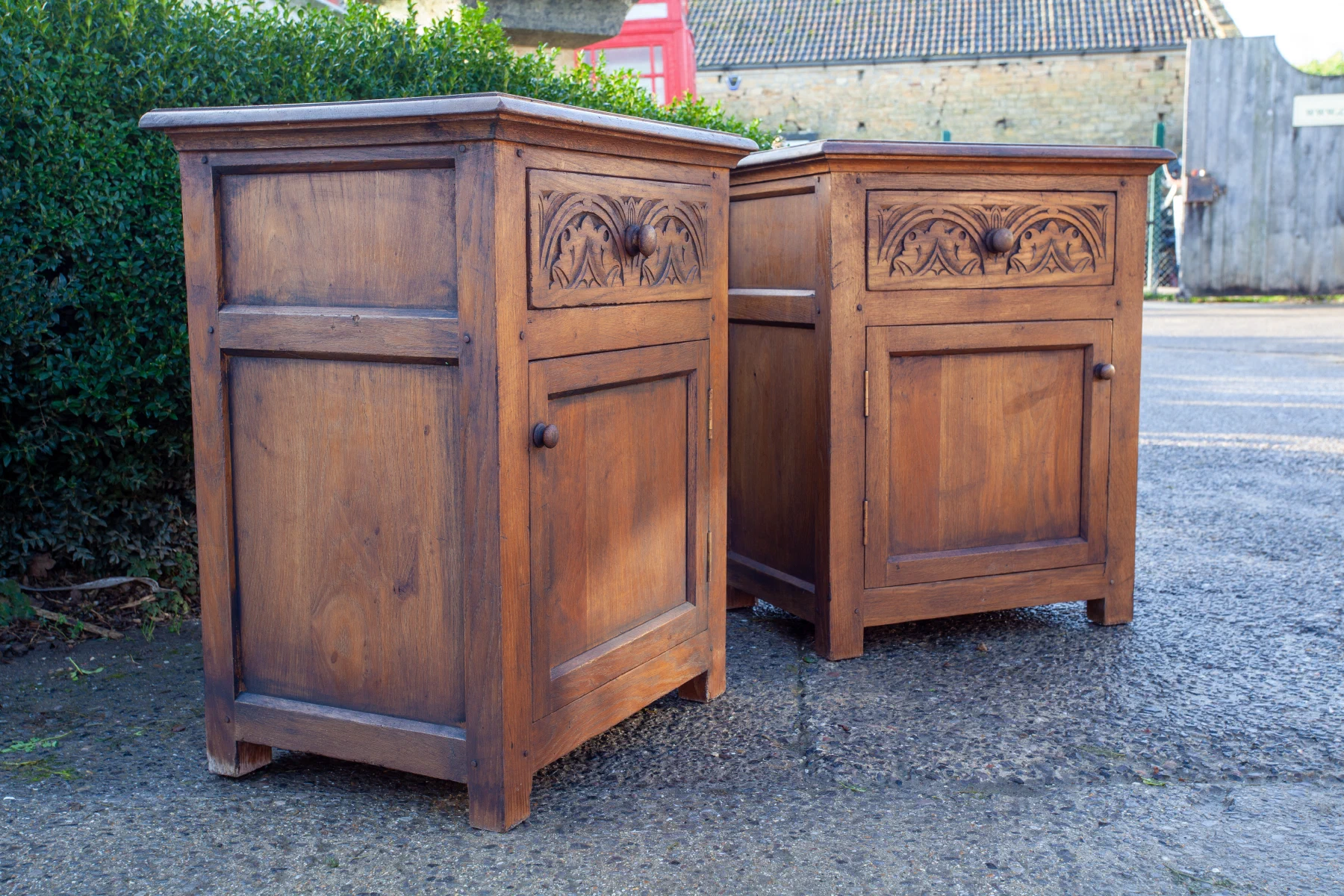 Pair of oak bedside cabinets with carved panels