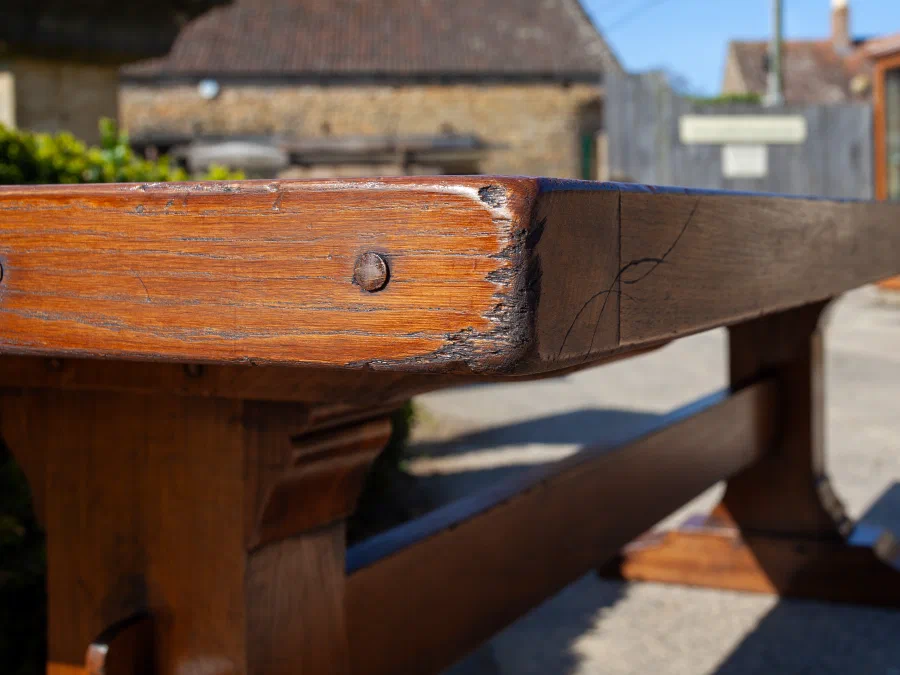 End of an oak refectory table showing the trestle and stretcher