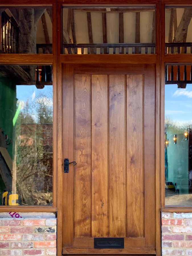Made-to-measure framed plank entrance door with glazed sidelights and toplights