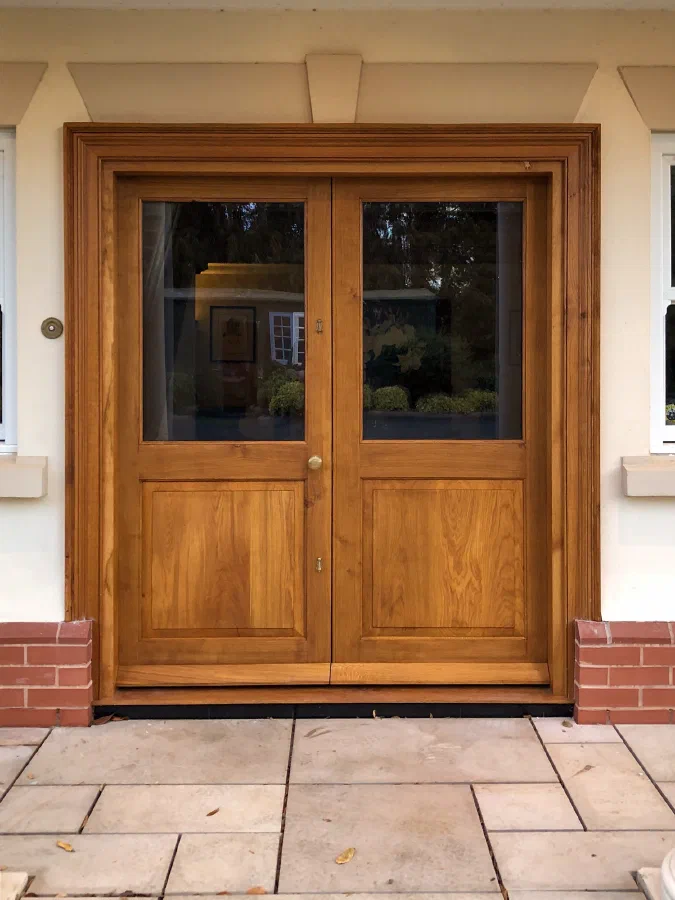 Pair of half-glazed oak doors within a moulded oak frame