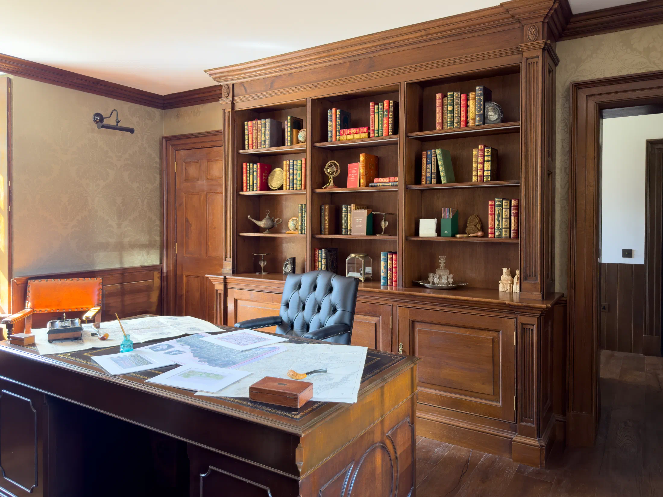 Georgian-style oak bookcase with lower cupboards in a study