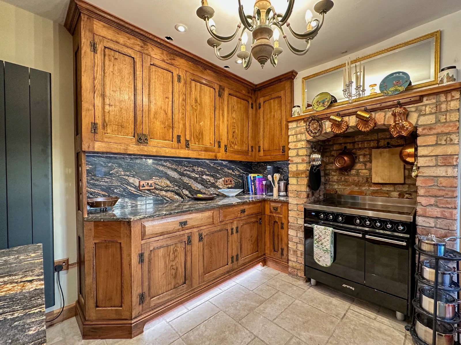 Traditional timber kitchen cabinetry fitted beside a brick range