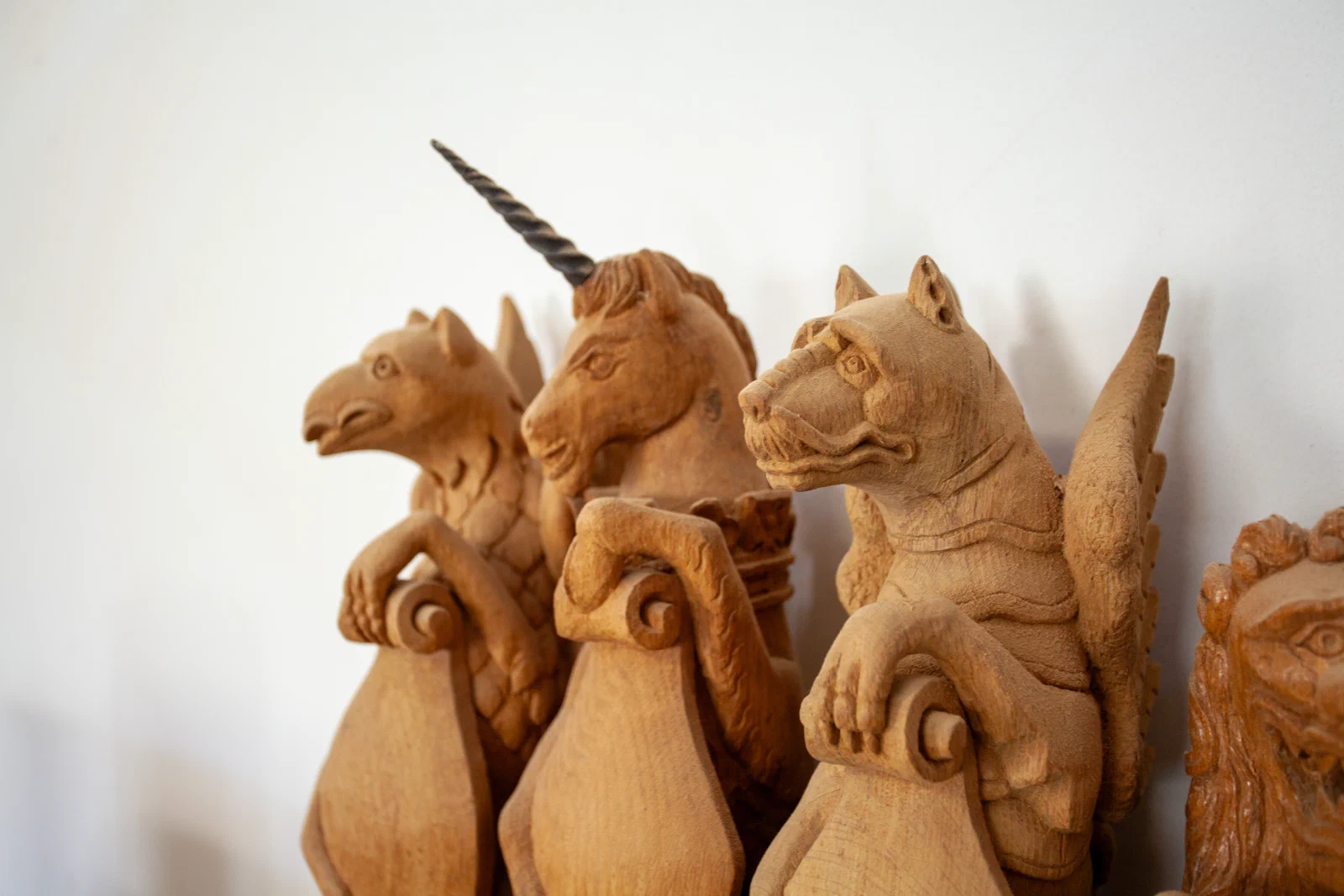 Carved heraldic animal studies gathered in the workshop