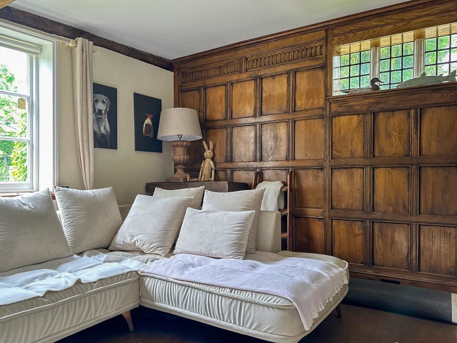 Oak panelling arranged around a sitting-room window