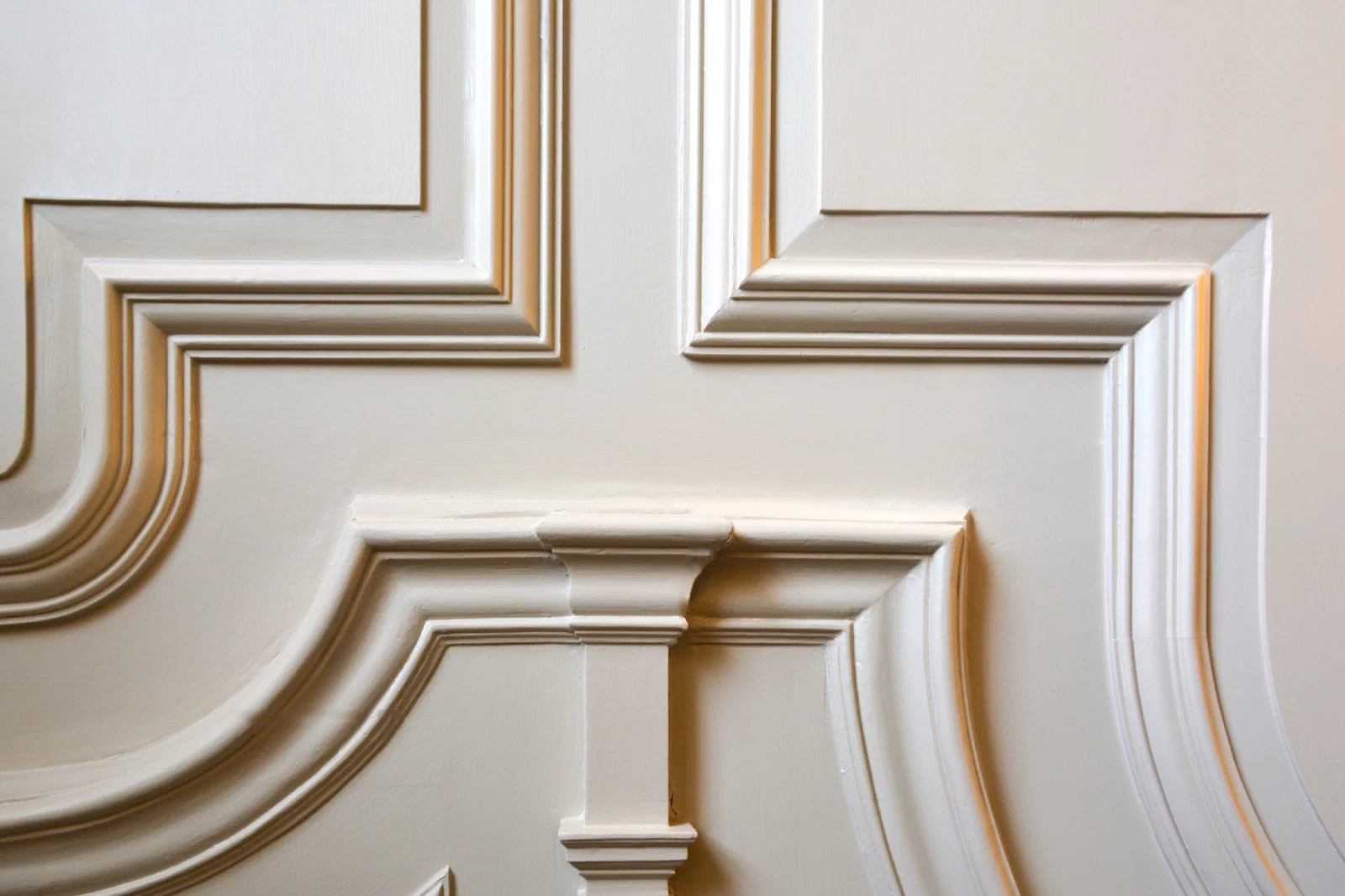 Close view of shaped painted bolection mouldings where panel frames meet