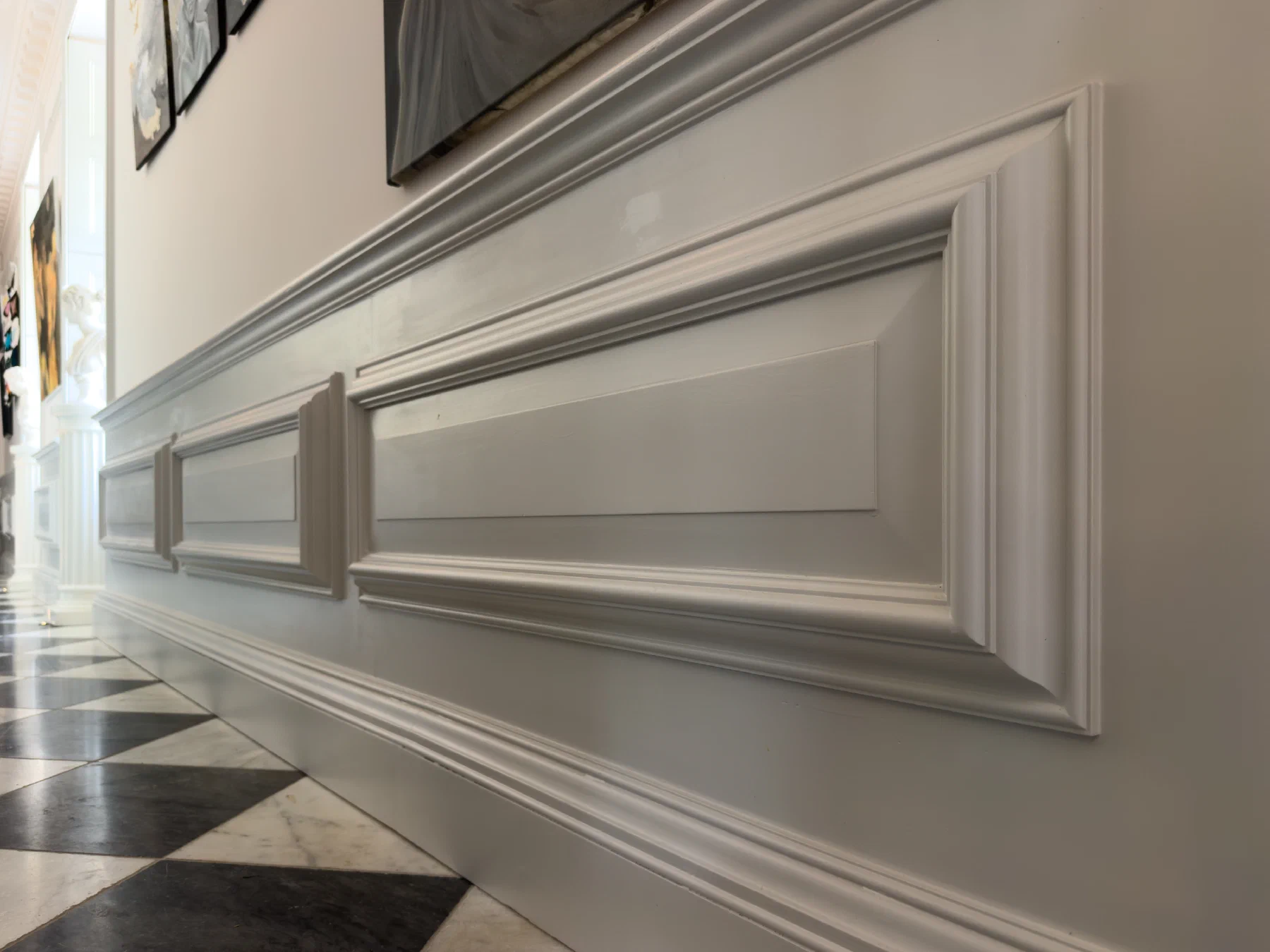 Close view along painted dado panelling with projecting mouldings