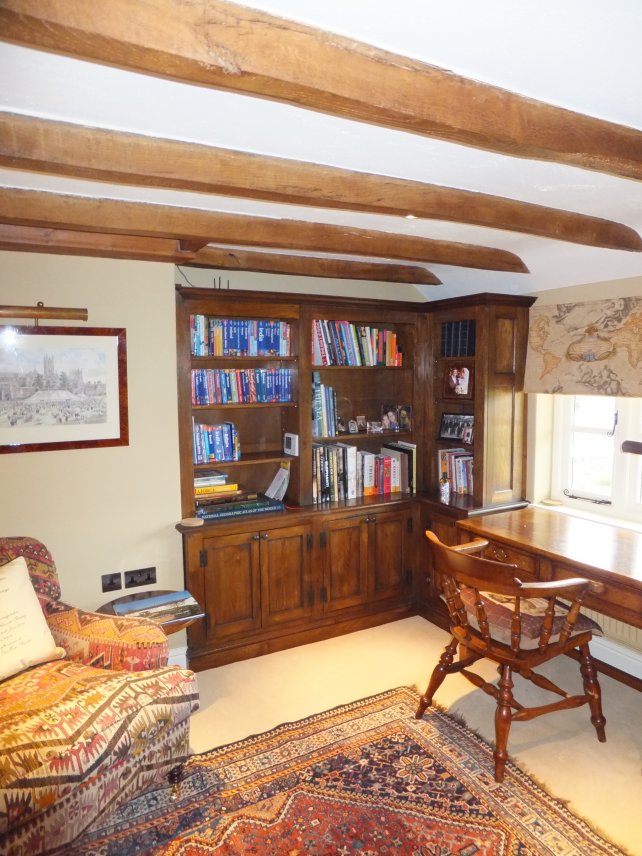 Bookcase in a snug with beamed ceiling