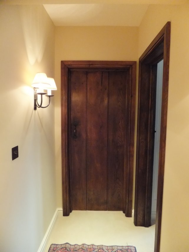 solid oak planked door complete with door lining, architrave and handmade ironwork