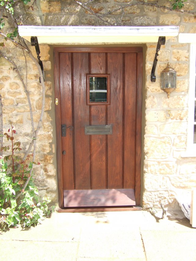 square topped door and frame with bead moulding, small window and ironwork
