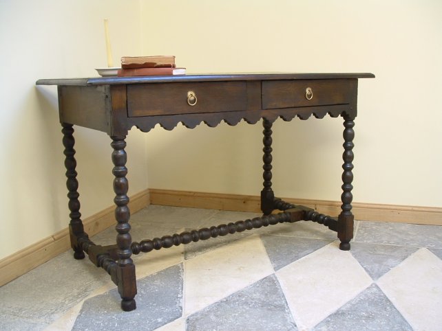 side table with scalloped detailing and hand carved legs and stretcher