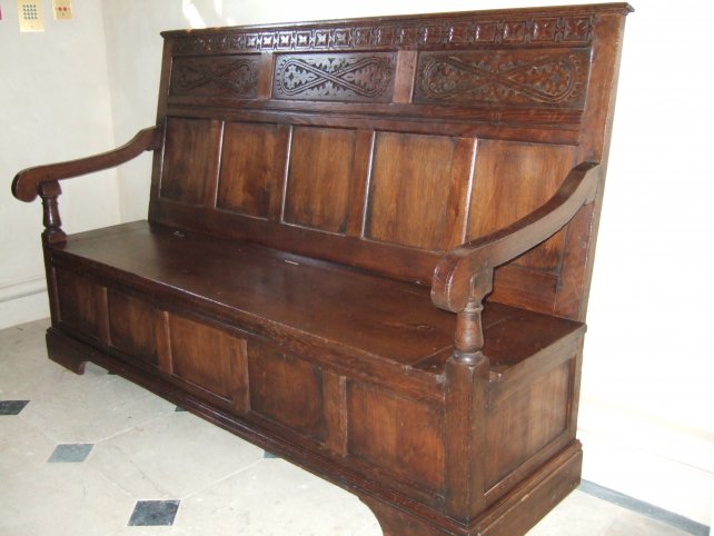 settle with carved strap work and lift up seat