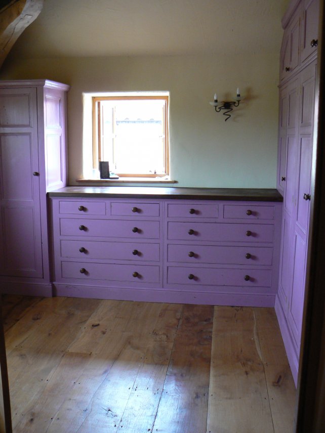 painted dressing room incorporating chest of drawers and wardrobes