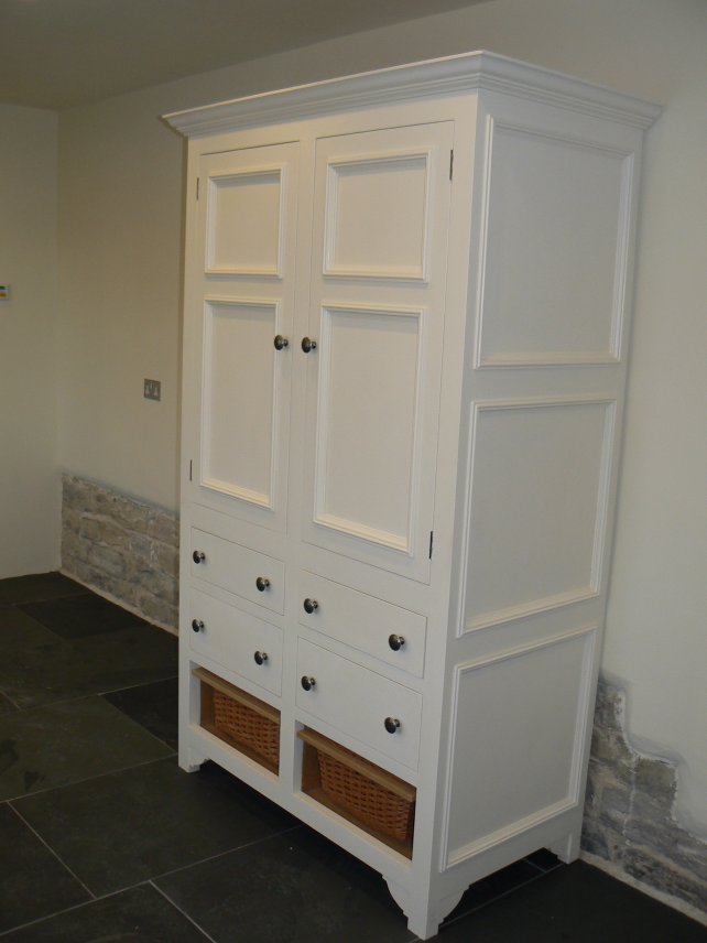 painted cooks cupboard with wicker baskets at the bottom