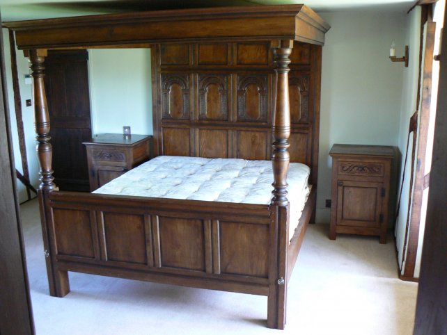 four poster bed with hand carved panels complete with matching bedside cabinets