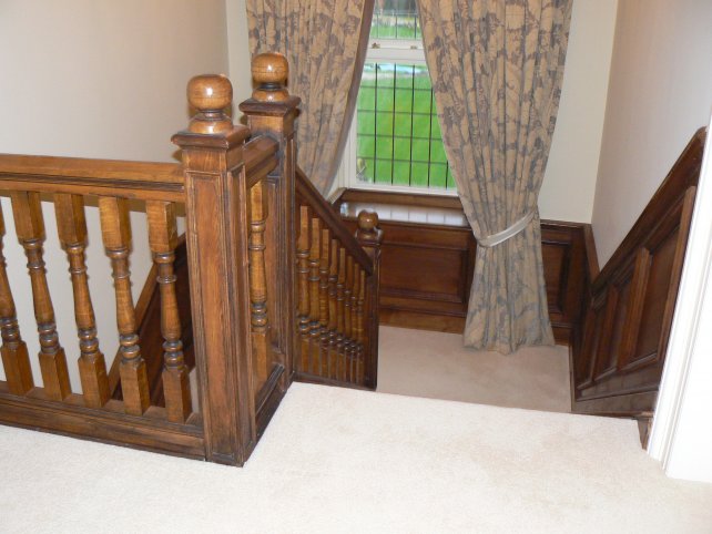 solid oak staircase with carved handrail and spindles, with sphere finials, waist height oak panelling