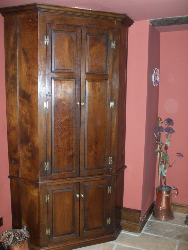 period corner cabinet in oak, aged and polished