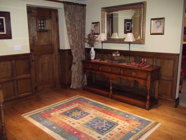 tudor style oak panelling with oak low dresser with shaped apron