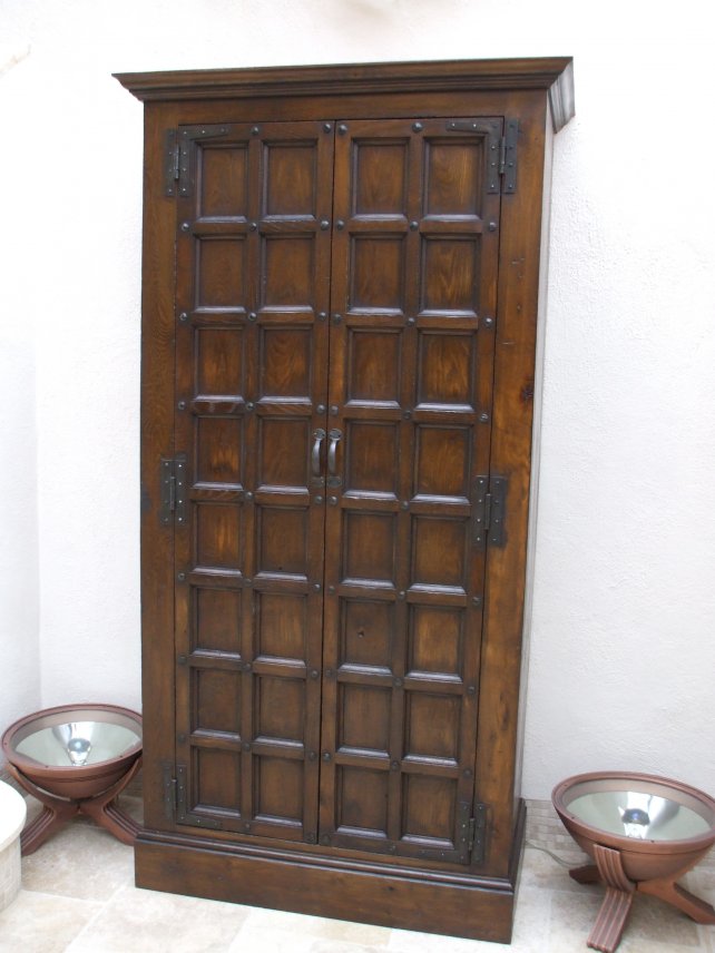 cupboard with small panels and hand carved ironwork