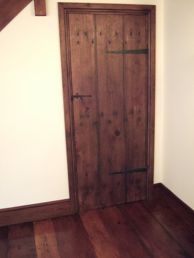 planked door with handmade T hinges and latch