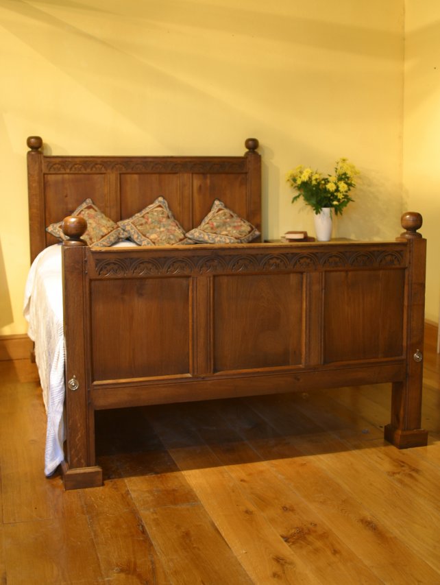 half headed bed in solid oak, aged and polished