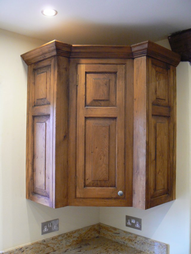 oak corner unit with fielded panels, aged and polished 