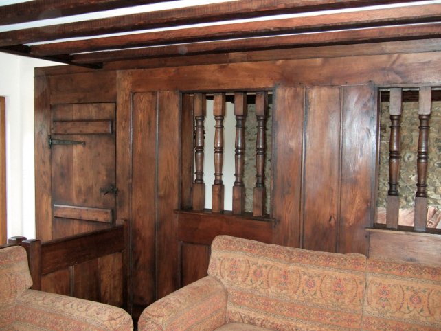 oak plank and muntin screen, hand turned baluster windows with shutters