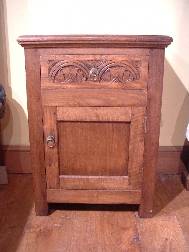 bedside cabinet in oak with hand carved drawer front