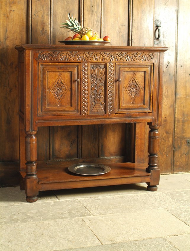 17th century livery cupboard with carved decoration and lozenge panel doors