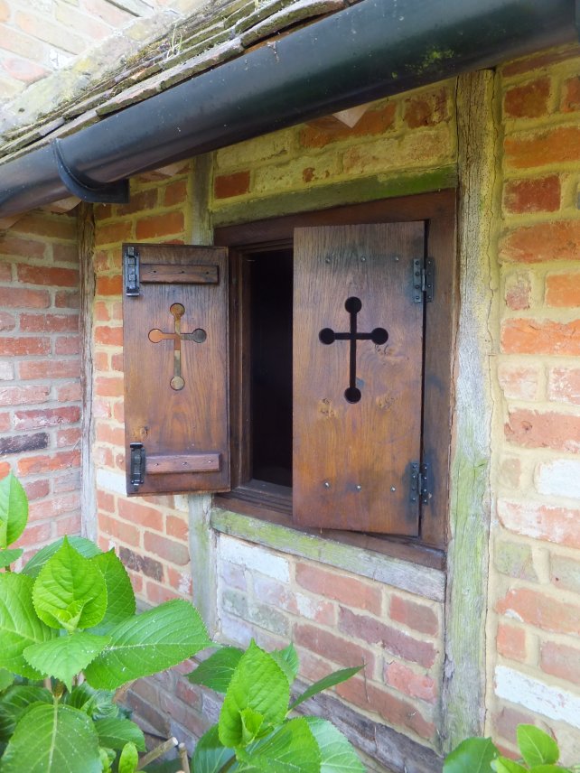 oak shutters with arrow slit detail