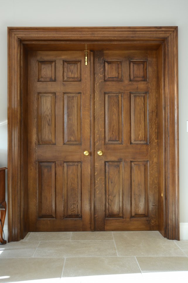 a pair of panelled oak doors, aged and polished