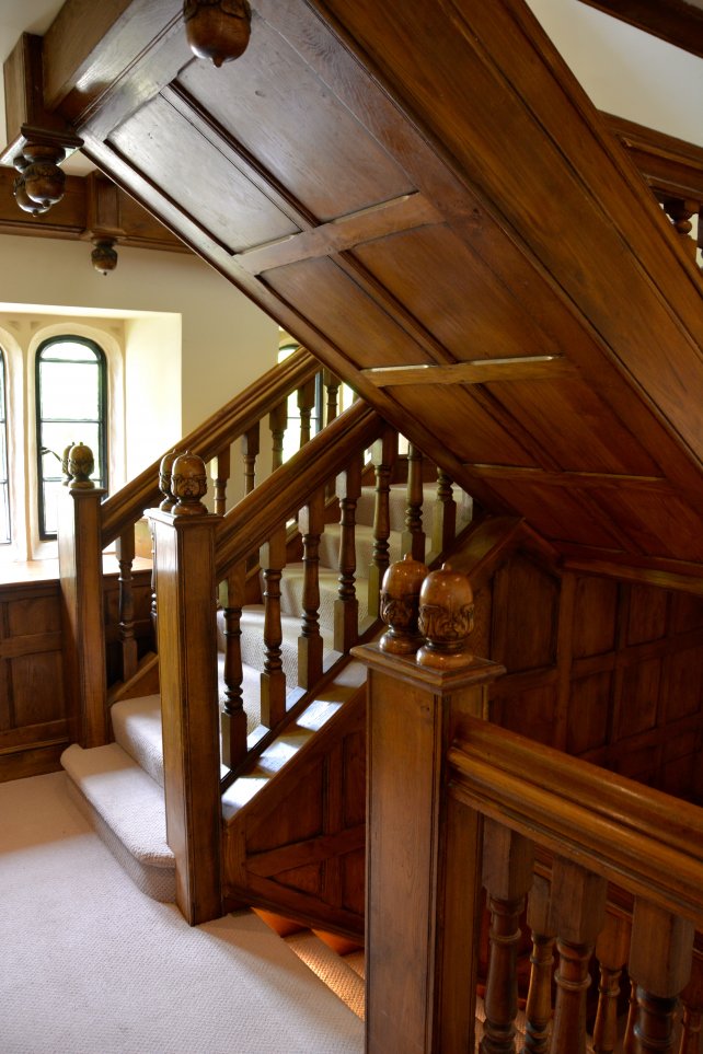 refurbished staircase with under stair panelling, hand carved acorn finials