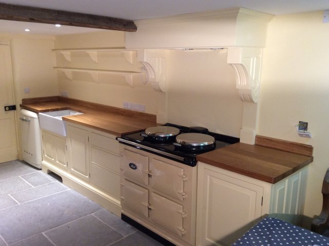 painted kitchen with wooden work top with Aga and Smeg appliances 