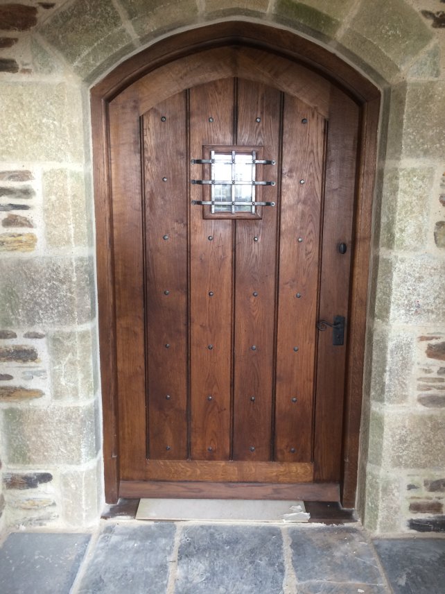 curved door and frame in solid oak with small window and grille