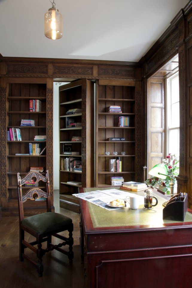 Secret door bookcase forming part of the library.  The library incorporated window seats, hand carved cornice and tudor style panelling