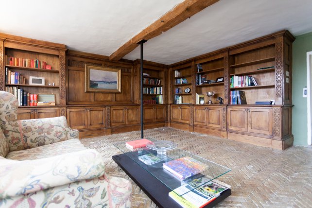 Bookcase library with secret door.  Lower cupboards having doors to hide media equipment