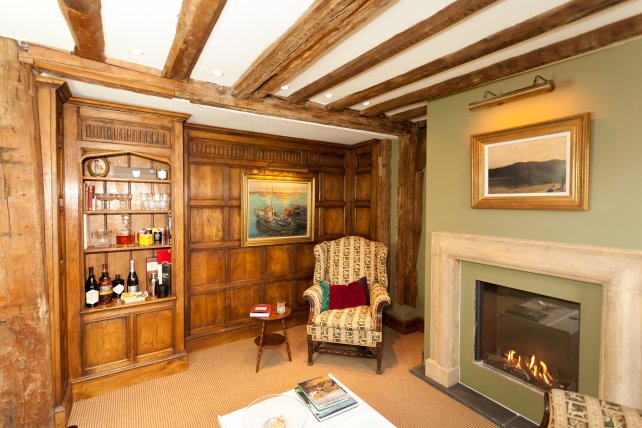 period wall panelling with hand carved fluted frieze and drinks cabinet