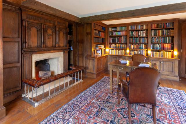 Home study with oak bookcases and carved overmantel