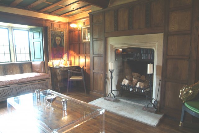 overmantel panelling around stone fireplace and oak flooring