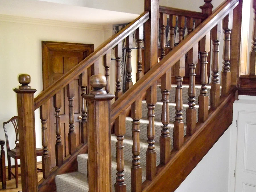 Traditional oak staircase with turned balusters and a fitted runner