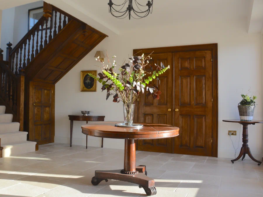 Oak staircase and panelled double doors in the entrance hall at Reed Farmhouse