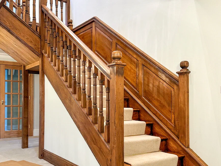 Traditional oak staircase with turned balusters and panelled walls